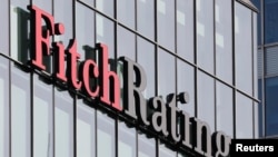 The Fitch Ratings logo is seen at their offices at Canary Wharf financial district in London, March 3, 2016. Fitch is abandoning the Brexit assumptions it used to set Britain's credit rating.