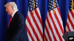 FILE - President Donald Trump walks away after speaking about the ongoing situation in Charlottesville, Va., at Trump National Golf Club in Bedminster, N.J., Aug. 12, 2017.