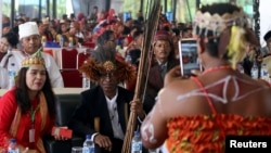 Participants take photos on the sidelines of an indigenous peoples gathering, near Medan, Sumatra Island, Indonesia, March 17, 2017.