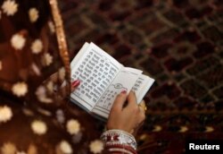 An Afghan Sikh woman prays inside a Gurudwara, or a Sikh temple, during a religious ceremony in Kabul, Afghanistan, June 8, 2016.