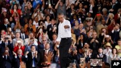 Former President Barack Obama reacts as he walks on stage at a rally in support of candidate for Senate Jacky Rosen and other Nevada Democrats, in Las Vegas, Oct. 22, 2018. 