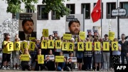 FILE - Activists of Amnesty International stage a protest against the detention of the head of Amnesty International in Turkey, Taner Kilic, in front of the Turkish Embassy in Berlin, Germany, June 15, 2017.