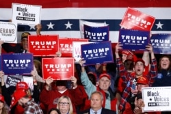 FILE - Supporters cheer as President Donald Trump speaks during a campaign rally, Feb. 28, 2020, in North Charleston, South Carolina, before the spread of the coronavirus in the United States.