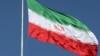 FILE - The Iranian flag is seen flying over a street in Tehran.