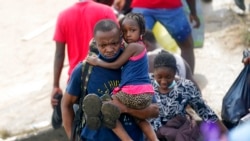 Haitian migrants use a dam to cross into the US from Mexico, Sept. 18, 2021, in Del Rio, Texas.