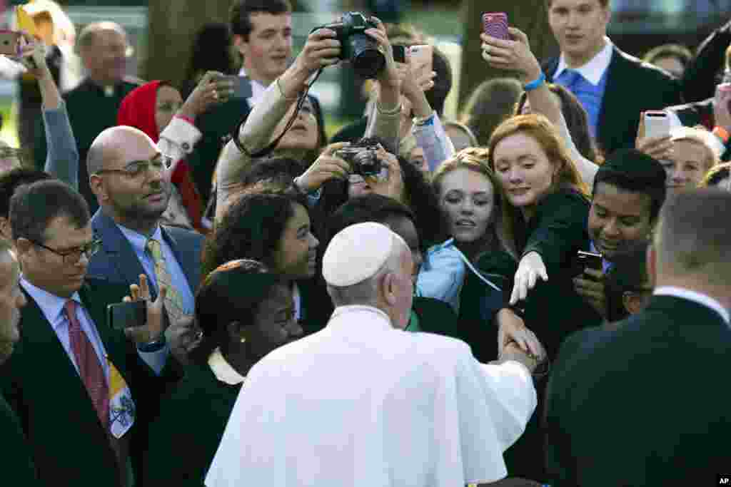 Pope Francis greets well-wishers while departing for the White House from the Apostolic Nunciature, the Vatican&#39;s diplomatic mission in Washington, Sept. 23, 2015.