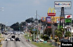 Police vehicles block access to part of Airline Highway after a fatal shooting of police officers in Baton Rouge, Louisiana; Sunday July 17, 2016.