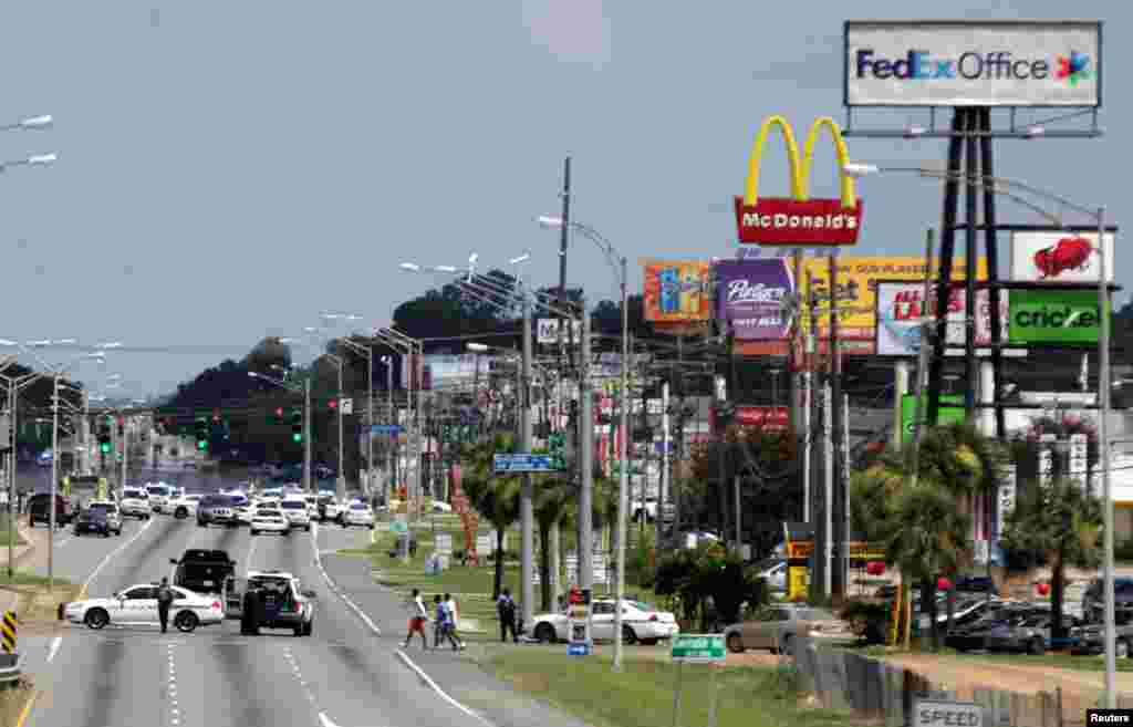 Police vehicles block access to part of Airline Highway after a fatal shooting of police officers in Baton Rouge, July 17, 2016.