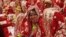 An Indian Muslim bride smiles, as she sits with other brides during a mass wedding organized by a social organization in Ahmadabad, India, Sunday, Feb. 15, 2015. 
