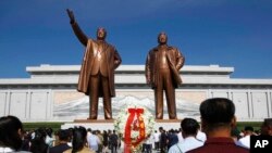 FILE - In this July 8, 2019, file photo, people visit Mansu Hill to pay tribute to the late leaders Kim Il Sung and Kim Jong Il on the occasion of the 25th anniversary of Kim Il Sung's death, in Pyongyang, North Korea.