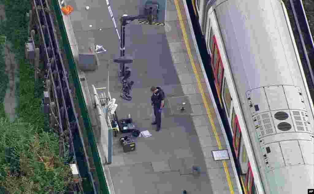 In this aerial image made from video, a police officer works at the Parsons Green Underground Station after an explosion in London Friday, Sept. 15, 2017. 