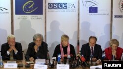 Members of the Parliamentary Assembly of the Organisation for Security and Cooperation in Europe (OSCE), led by Walburga Habsburg Douglas, center, attend news conference, Kiev, Oct. 29, 2012.
