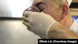 Using a small bowl, Ekber Kayser checks the taste of the polo.