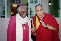 In this file photo taken on Aug. 21, 1996 Archbishop Desmond Tutu (L) meets the Dalai Lama, spiritual and political leader of the Tibetan people, in the garden of the Mount Nelson Hotel in Cape Town.