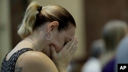 A parishioner attends mass celebrated by Bishop Ronald Gainer, of the Harrisburg Diocese, at the Cathedral Church of Saint Patrick in Harrisburg, Pa., Aug. 17, 2018.
