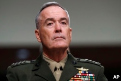 FILE - Joint Chiefs Chairman Gen. Joseph Dunford on Capitol Hill in Washington, June 13, 2017. Military chiefs will seek a six-month delay before letting transgender people enlist in their services, officials said June 23.