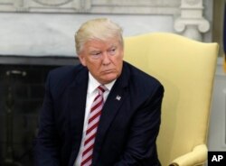 President Donald Trump talks to reporters in the Oval Office of the White House in Washington, May 10, 2017.