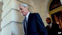 FILE - Former FBI Director Robert Mueller, the special counsel probing Russian interference in the 2016 election, departs Capitol Hill following a closed door meeting in Washington, June 21, 2017.