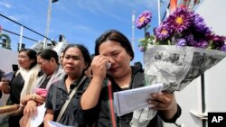 Relatives of the victims of the ferry that sank on June 18 weep during a prayer on a ship on Lake Toba, North Sumatra, Indonesia, July 3, 2018. 