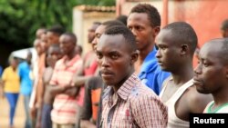 Suspected fighters are paraded before the media by Burundian police after clashes in the capital Bujumbura, Burundi, Dec. 12, 2015. 
