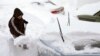 George Salman from Norwood, Massachusetts, digs his car out, Jan. 28, 2015, after a powerful storm hit the northeastern U.S. this week. The snowstorm was not linked to global warming, although scientists say that we can expect more extreme weather as the planet warms.