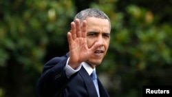 FILE - President Barack Obama waves as he walks towards Marine One on the South Lawn at the White House in Washington.
