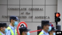 Policemen walk past the U.S. consulate in Chengdu, southwestern China's Sichuan province, on July 26, 2020.