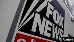 FILE — In this undated photo, a Fox News sign identifies a vehicle in New York. Former Donald Trump supporter Ray Epps has filed a defamation lawsuit against Fox News, saying the network made him a scapegoat for the U.S. Capitol insurrection.