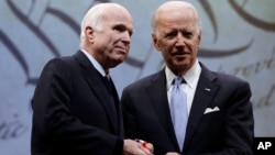 Sen. John McCain, R-Ariz., receives the Liberty Medal from Chair of the National Constitution Center's Board of Trustees, former Vice President Joe Biden in Philadelphia, Monday, Oct. 16, 2017. 