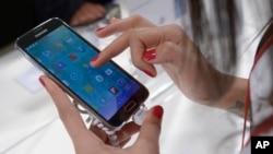 FILE - the Samsung Galaxy S5 is displayed at the Mobile World Congress in Barcelona, Spain, Tuesday, Feb. 25, 2014. 