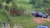 The car carrying Ugandan opposition leader Kizza Besigye is stopped by Ugandan police near to his home in Kasangati, Uganda, as observers look on, May 19, 2011