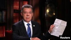 FILE - Colombia's President Juan Manuel Santos speaks during a presidential address in Bogota, Oct. 10, 2016.