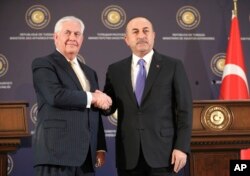 Turkey's Foreign Minister Mevlut Cavusoglu, right, shakes hands with U.S. Secretary of State Rex Tillerson, left, after a joint news conference following their meeting in Ankara, Turkey, Feb. 16, 2018.