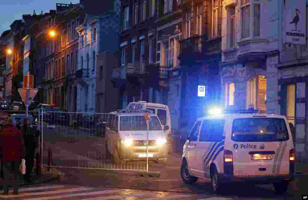 Belgian police officers guard a street in Verviers, Belgium, Jan. 16, 2015.