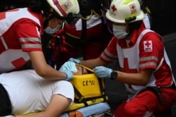People take part in an earthquake drill, the first since the beginning of the COVID-19 pandemic, in Mexico City on June 21, 2021.