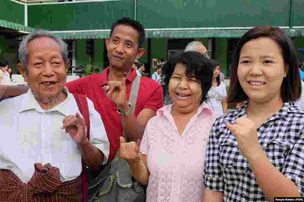 Sein Kyi, 87, and his family members display their inked fingers after voting in Yangon, Nov. 8, 2015.