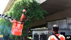 A team of migrant workers from India trim the trees along Holland Road in Singapore on Sunday, Apr. 19, 2020.