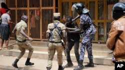 FILE - Ugandan security forces briefly beat then detain a protester in downtown Kampala, Uganda, Aug. 20, 2018. Two women say they were assaulted by Ugandan security officers in an August 13 incident.