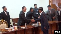 លោក ហ៊ុន សែន និង លោក សម រង្ស៊ី ចាប់​ដៃ​គ្នា​នៅ​មុន​ពេល​ប្រជុំ​ចរចា​ជា​លើក​ទី​២ នៅ​ថ្ងៃ​ទី​១៧ ខែ​កញ្ញា ឆ្នាំ​២០១៣។ (សាយ មុន្នី វីអូអេ)