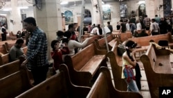 People look at damage inside a church in Tanta, Egypt, after a suicide bombing, April 9, 2017. Bombs exploded at two Coptic churches in the northern Egyptian cities of Tanta and Alexandria as worshippers were celebrating Palm Sunday, killing 45 people and wounding dozens more in assaults claimed by the Islamic State group. (AP Photo/Nariman El-Mofty)
