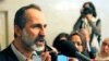 Syrian National Coalition chairman Moaz Al-Khatib is center of debate among opposition about whether to create interim government. Shown here February 13, 2012 after Arab League meeting in Cairo. (AP) 