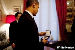 FILE - President Barack Obama looks at the Nobel Peace Prize medal for the first time at the Norwegian Nobel Institute in Oslo, Norway, Dec. 10, 2009. (White House/Pete Souza)