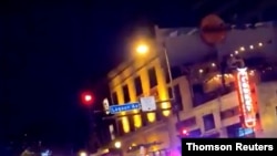 Police vehicles block the road after a shooting in Minneapolis, Minnesota, June 21, 2020, in this picture obtained from social media video.