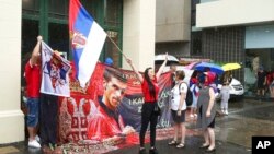 Protesters gather outside an immigration detention hotel where Serbia's Novak Djokovic is believed to stay, in Melbourne, Australia, Jan. 7, 2022.
