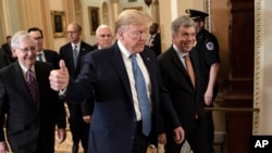 FILE - President Donald Trump, accompanied by Vice President Mike Pence, rear, Senate Majority Leader Mitch McConnell, left, and Sen. Roy Blunt, arrives to speak with lawmakers on Capitol Hill in Washington, March 10, 2020.