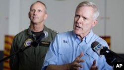 FILE - Secretary of the Navy, Ray Mabus, right, gestures during a press conference.