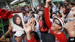 Supporters of Thailand's former Prime Minister Yingluck Shinawatra dance outside the Supreme Court after Yingluck failed to show up to hear a verdict in Bangkok Thailand, Aug. 25, 2017.