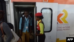 FILE - Passengers disembark upon arrival in a Mombasa-to-Nairobi train launched to operate on the Standard Gauge Railway (SGR), May 31, 2017. New details about a contract signed in 2014 reveal what’s at stake if Kenya defaults on its loan to the Export-Import Bank of China.