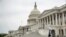 A man wearing a mask jogs past the U.S. Capitol Building, April 28, 2020, in Washington.