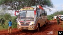 FILE - Kenyan security forces and others gather around the scene on an attack on a bus in November 2014 in northeastern Kenya.